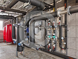 Interior of industrial, gas boiler room with boilers; pumps; sensors and a variety of pipelines