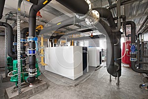 Interior of industrial, gas boiler room with boilers; pumps; sensors and a variety of pipelines