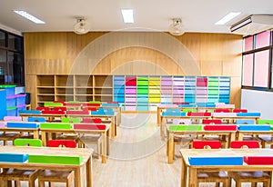 Interior of kindergarten classroom consist desks and chairs