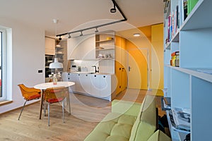 Interior of kitchen with dining table in urban apartment