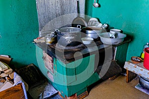 Interior of the kitchen of an old country house. Old cooking stove with dishes. The kitchen is in use