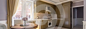 Interior of kitchen in residential house or hotel. Panoramic view of nice home interior in daylight