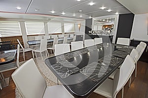 Interior of large salon dining area of luxury motor yacht