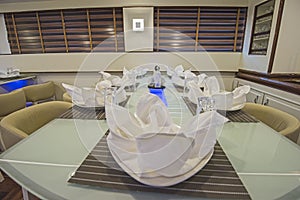 Interior of large salon dining area of luxury motor yacht