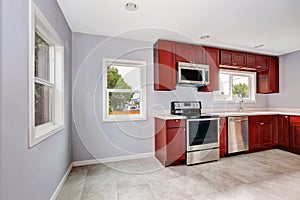 Interior of lavender kitchen with burgundy cabinets