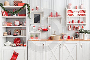 Interior light grey kitchen and red christmas decor. Preparing lunch at home on the kitchen concept.