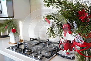 Interior light kitchen and red christmas decor. Focus on tree