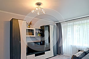 The interior of the living room with furniture in black and white colors