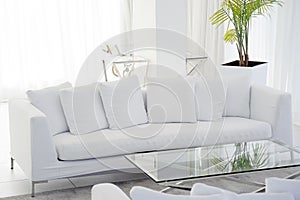 Interior of the living room of the hotel. Beautiful living room with white sofa. White Concept Living Room Interior. Modern bed