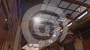 Interior of local market in Fez, Morocco. Massive doors of counters are closed on padlocks. From above, market is