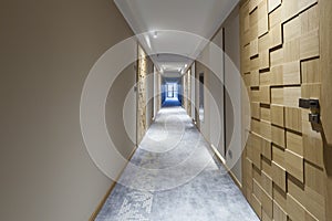 Interior of a long hotel corridor