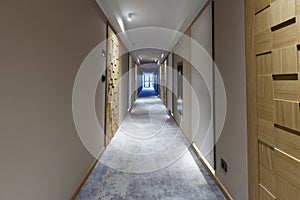 Interior of a long hotel corridor