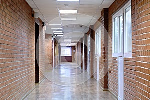 Interior of a long room with masonry and plastic photo