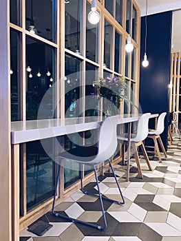 Interior of lovely cafe with white and blue chairs