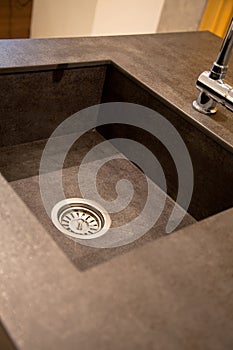Interior of modern kitchen and ceramic sink and tap