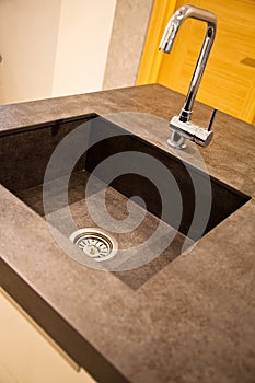 Interior of modern kitchen and ceramic sink and tap