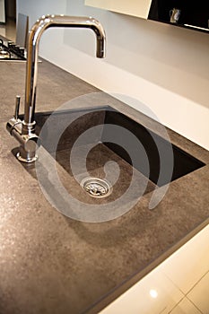Interior of modern kitchen and ceramic sink and tap