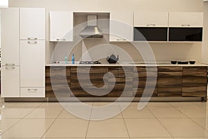 Interior of luxurious modern kitchen and walnut white cabinets