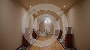 Interior of luxury spa facilities. Empty hallway of wellness center or clinic. Hotel corridor dolly shot. No people