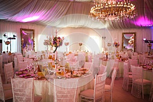 Interior of a luxury white wedding tent decoration ready for guests photo