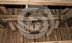 Interior and mechanism of an old wooden mill of the 18th century