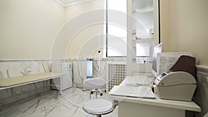 Interior of a medical cabinet at the hospital. Action. Empty medical room with couch for patients and medical equipment.