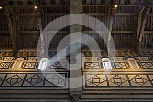Interior of the medieval church of San Miniato in Florence with beam of light from the window