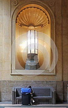 Interior of Milan central station with a monumental art deco lamp