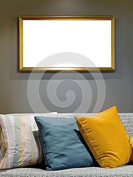 Interior mockup blank picture frame in horizontal with clipping path hanging on wall with decor bright interior, colorful sofa and