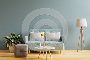Interior mockup with sofa in living room with empty blue wall background