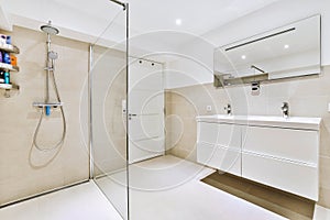 Interior of modern bathroom with glass shower cabin