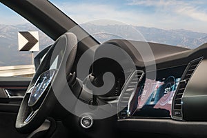 Interior of a modern car with displays on the dashboard and steering wheel with the possibility of autonomous driving