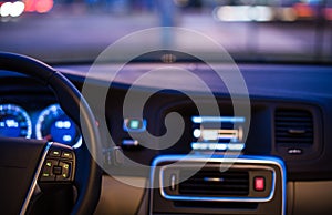 Interior of a modern car at night in a city