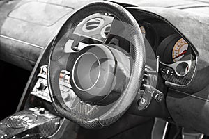 Interior of a modern car, steering wheel and dashboard.