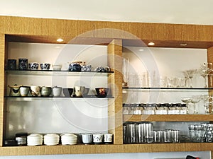 Interior of a modern coffee shop with wooden shelves and cupboards