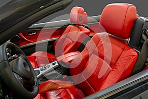 Interior of a modern convertible car with red leather seats