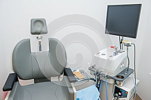 Interior of modern ENT clonic. Professional EVO ENT Medical Devices Workstation and chair in office. Ear Nose and Throat Medical e