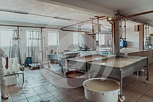 The interior of a modern factory for the processing of dairy products and the production of various types of cheese