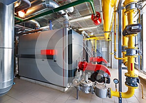 The interior of a modern gas boiler house with boilers, pumps, v