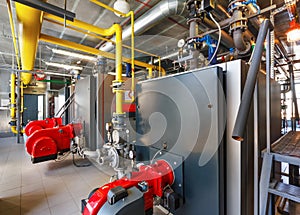 The interior of a modern gas boiler house with boilers, pumps, v