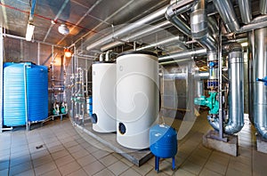 The interior of a modern gas boiler house with pumps, valves, a