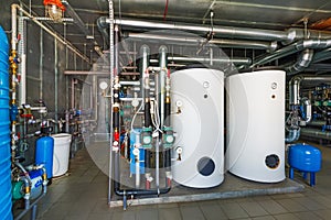 The interior of a modern gas boiler house with pumps, valves, a