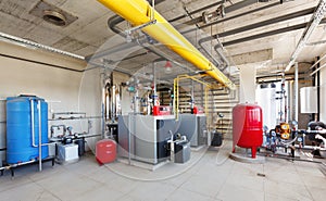 Interior of a modern gas boiler room, with a water treatment system, many valves and sensors