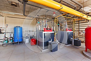 Interior of a modern gas boiler room, with a water treatment system, many valves and sensors