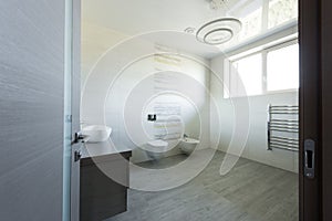 interior of modern grey bathroom with toilet and bidet view