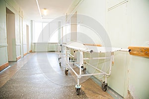 An interior of a hospital hallway with a stretchers