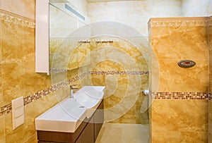 Interior modern house, bathroom with marble tiles.