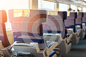 Interior of modern intercity express train. Back view of wide comfortable seats in row at railroad transport