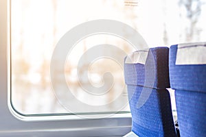 Interior of modern intercity express train. Back view of wide comfortable seats in row at railroad transport