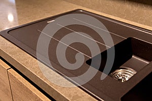 Interior of modern kitchen and acrylic sink and drain